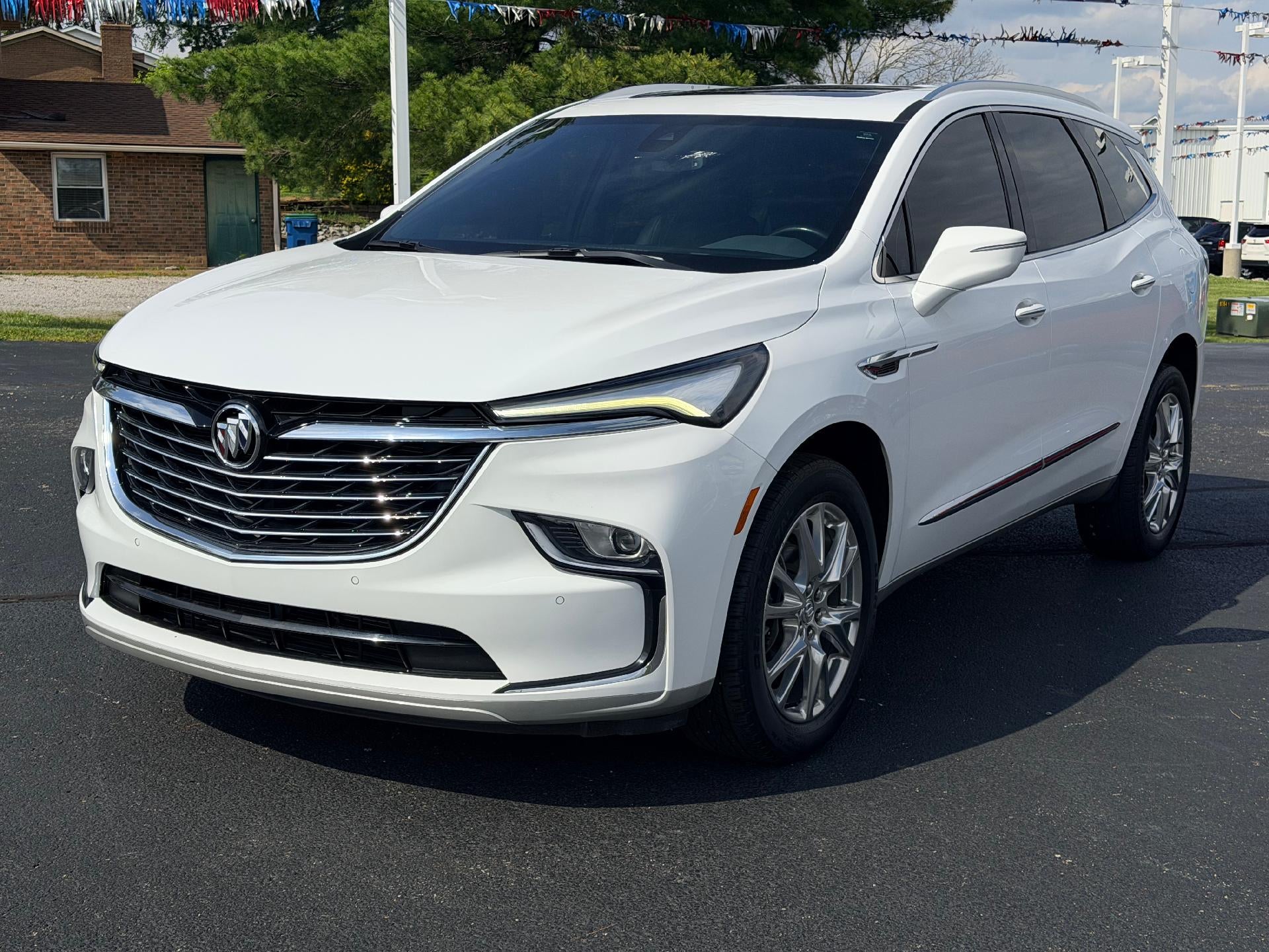 2023 Buick Enclave Essence in Summit White — front three-quarter view