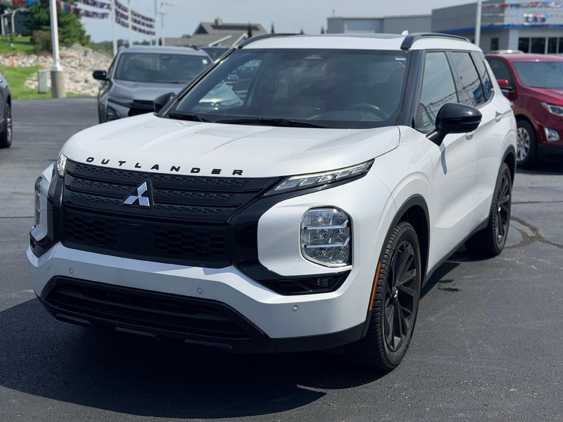 2024 Mitsubishi Outlander SEL in White — front three-quarter view